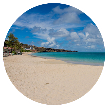 A beach in a circle with a blue sky and white sand, perfect for snorkeling in Grenada.